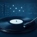 Close-up of a vinyl record player against a digital background